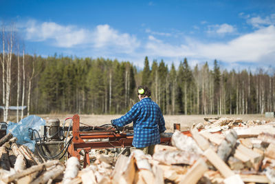 Mature woman working in sawmill