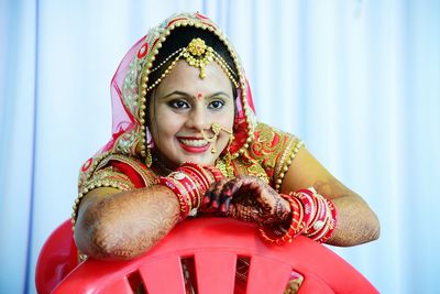 Close-up of bride against curtains