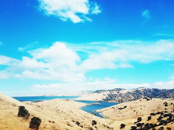 Panoramic view of landscape against blue sky