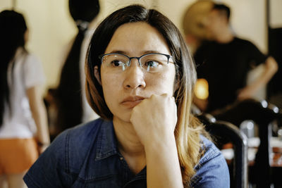 Close-up of thoughtful woman sitting in restaurant