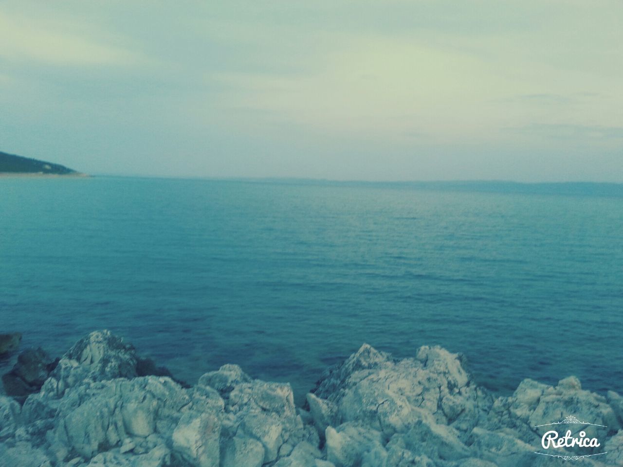 sea, water, scenics, beauty in nature, tranquil scene, tranquility, sky, horizon over water, nature, rock - object, idyllic, cloud - sky, day, mountain, outdoors, high angle view, blue, no people, remote, seascape