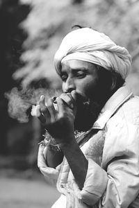 Portrait of man smoking outdoors
