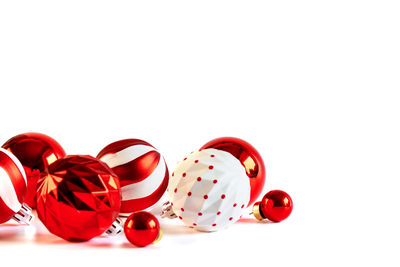 Close-up of red heart shape over white background