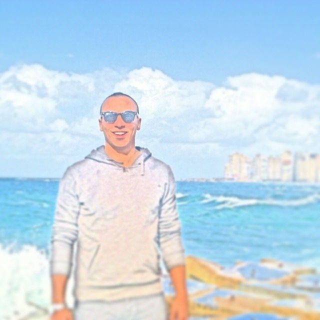sea, water, lifestyles, sky, leisure activity, standing, casual clothing, sunglasses, waist up, person, three quarter length, young adult, focus on foreground, rear view, blue, beach, young men, cloud - sky