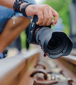 Close-up of people working on metal