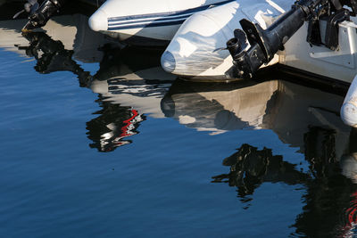 Reflection of man in boat on sea