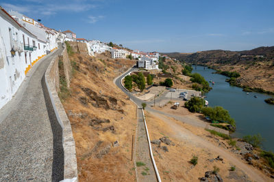 High angle view of road by buildings against sky