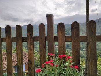 Scenic view of red wooden fence against sky