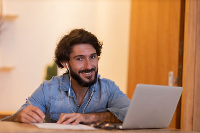 Young business man working with laptop. gray notebook for working. home office . 