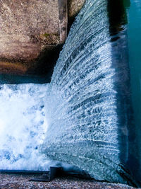 Close-up of water flowing in river against sky