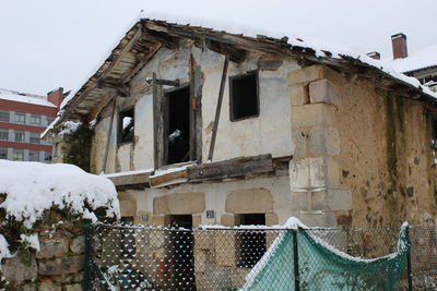 Old building against sky during winter