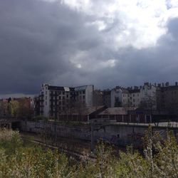Buildings against cloudy sky