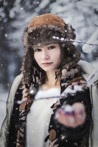 Portrait of woman outdoors during snowfall