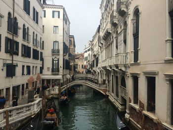 Boats in canal along buildings