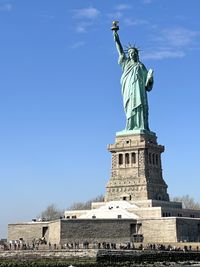 Low angle view of statue of liberty against sky