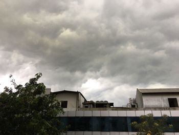 Low angle view of building against cloudy sky