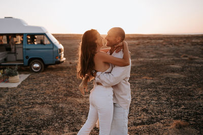 Friends standing on land against sky