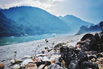 Scenic view of sea and mountains against sky