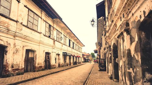 Narrow street amidst buildings in city