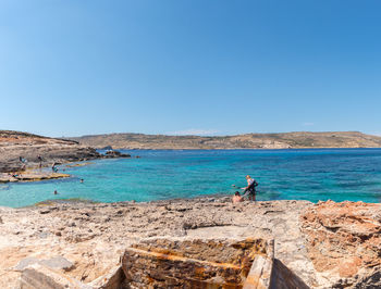 Scenic view of sea against clear blue sky