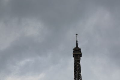 Low angle view of tower against cloudy sky