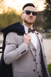 Young man wearing sunglasses while standing outdoors