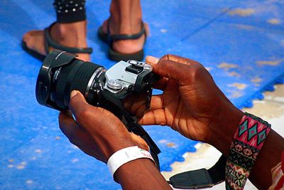 Close-up of hands holding camera