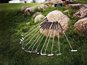 Golf clubs on grassy field