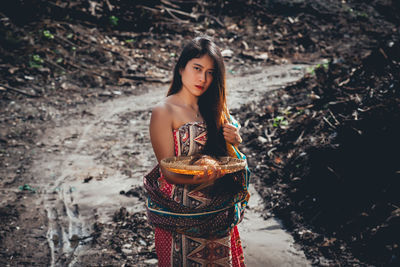 Portrait of woman standing outdoors