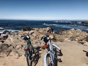 Bicycle on beach against sky