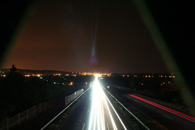 Light trails on road in city at night