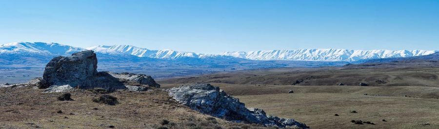Scenic view of mountains against blue sky