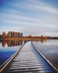 Pier over lake against sky