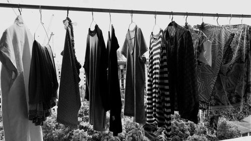 Close-up of clothes hanging in row