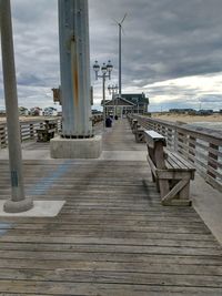 Pier amidst footpath against sky