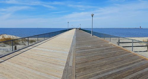 Pier over sea against sky