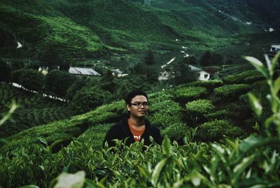 Man standing at tea plantation in cameron highlands