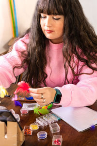 Portrait of young woman using laptop at home