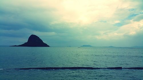 Scenic view of sea against cloudy sky