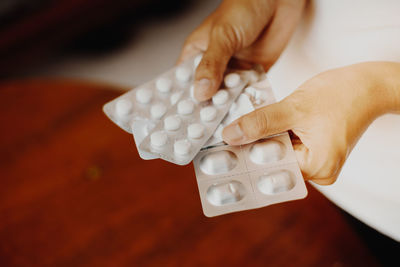 Midsection of man holding medicines