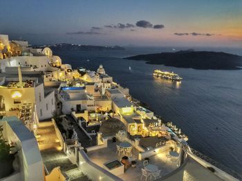 High angle view of city by sea against sky