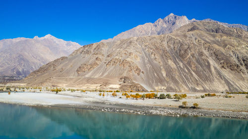 Scenic view of mountains against blue sky