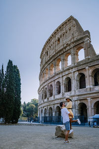 Couple standing against ancient built structure