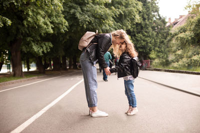 Full length of woman walking on road in city