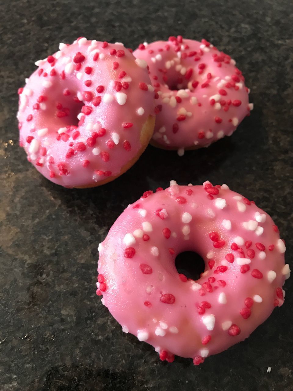 CLOSE-UP OF PINK STRAWBERRY ON CAKE