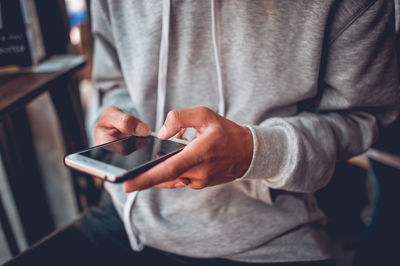 Close-up of man using mobile phone