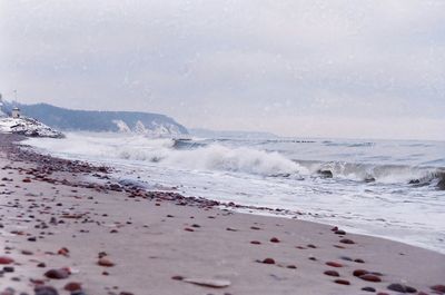 Scenic view of waves crashing at shore of beach