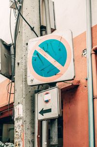 Low angle view of road sign against building