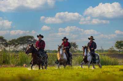 Cowboys riding horses beside the river and lifestyle with natural light background.