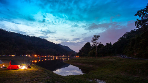 Scenic view of lake by trees against sky